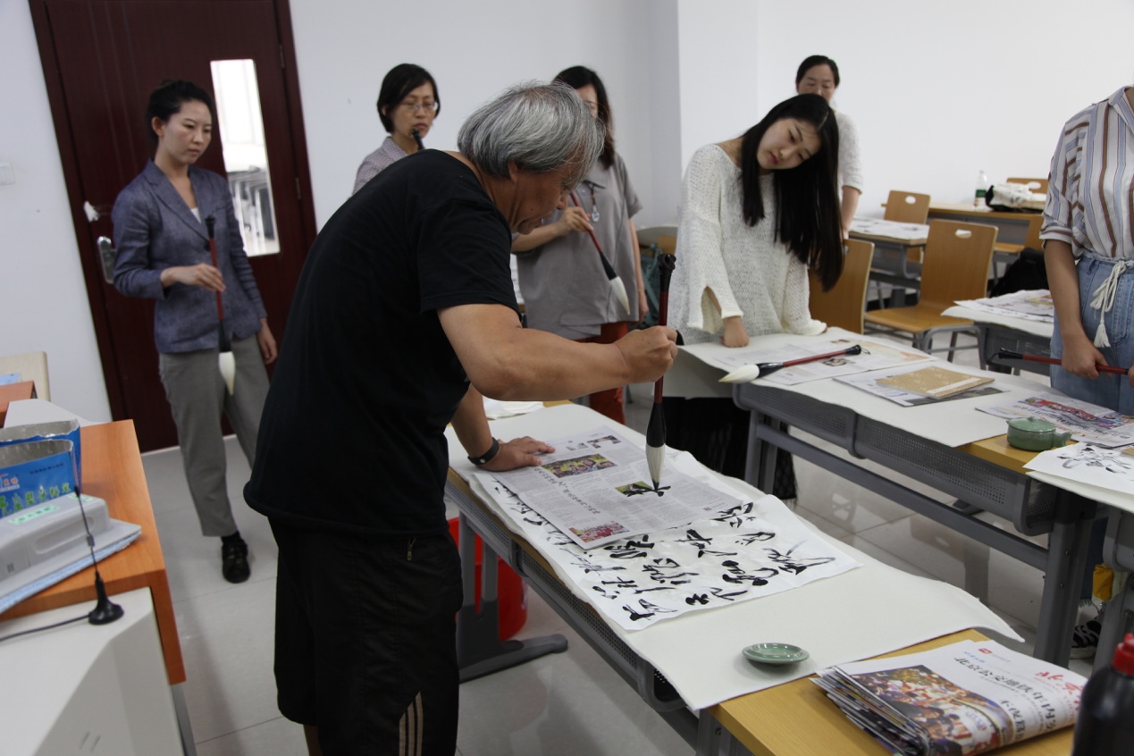 A group of people standing in a kitchen preparing foodDescription automatically generated